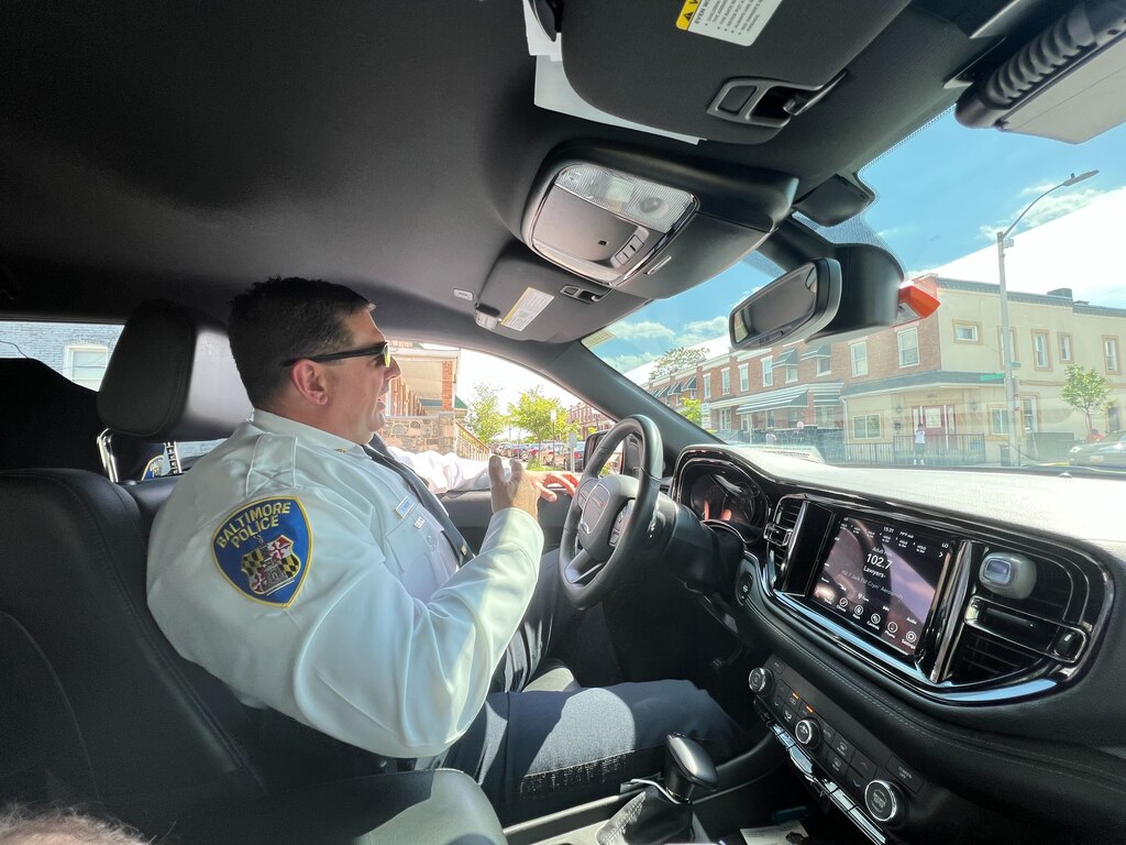 Eastern District Maj. Guy Thacker sits in his vehicle keeping an eye on the corner of North Potomac and East Preston streets, where he says there is concern about the potential for violence. Police no longer "clear corners," but do approach or keep an eye on people clustering in areas of concern. Residents say it's harassment.