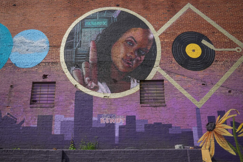 A mural of DJ K-Swift is painted on the wall of Hammerjacks in South Baltimore, painted by artist Nether410.