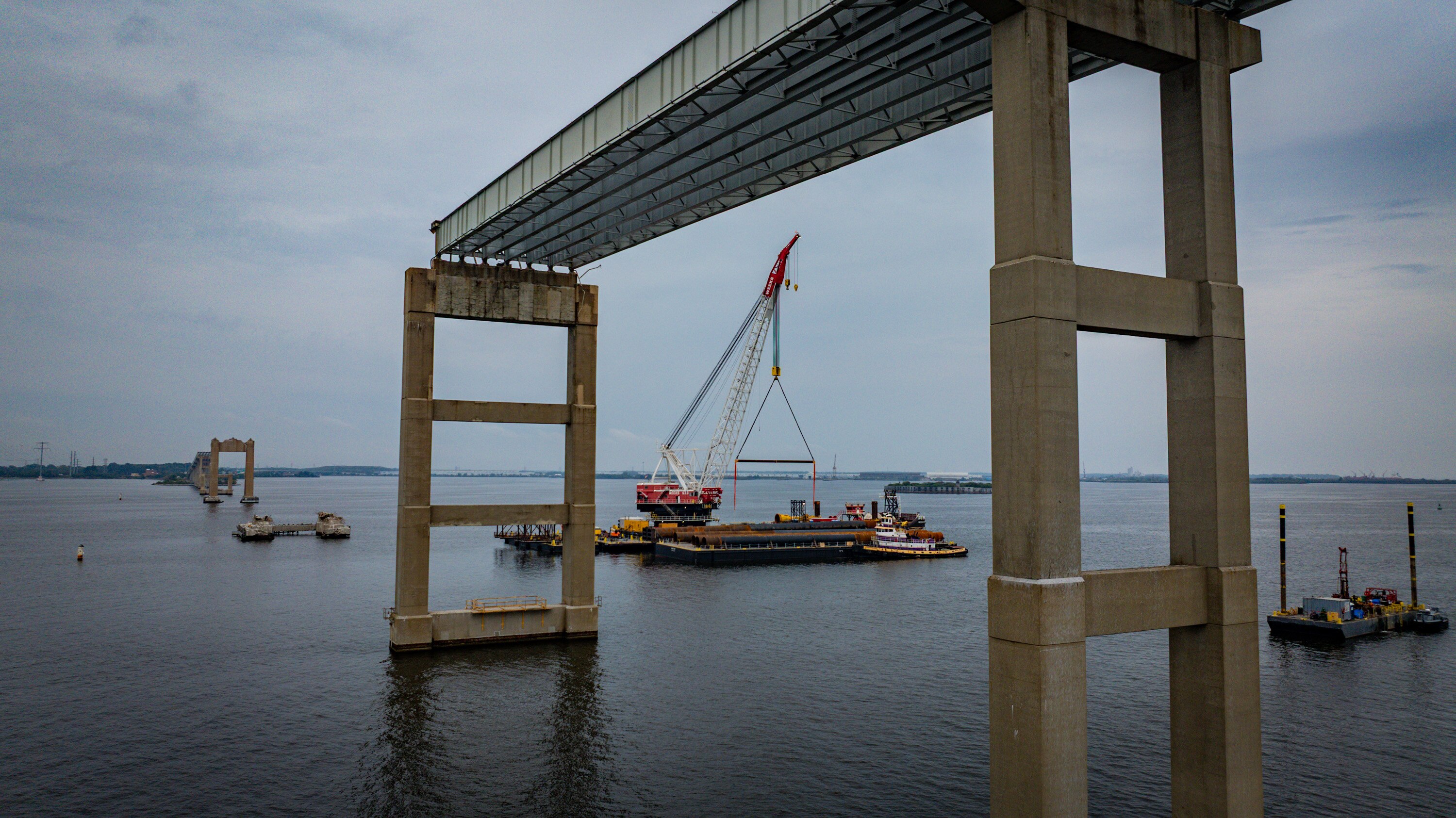 Preliminary stages of the Key Bridge rebuild have begun, with testing on piles driven into the riverbed. 