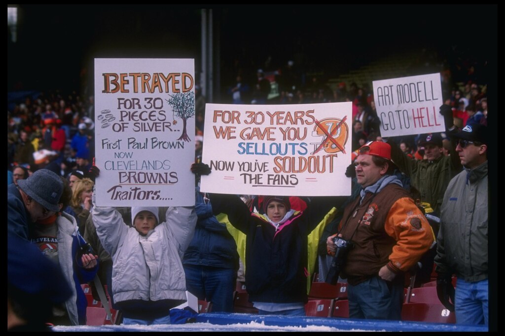 5 Nov 1995: Cleveland Browns fans with signs look on during a game against the Houston Oilers at Cleveland Stadium in Cleveland, Ohio. The Oilers won the game, 37-10.