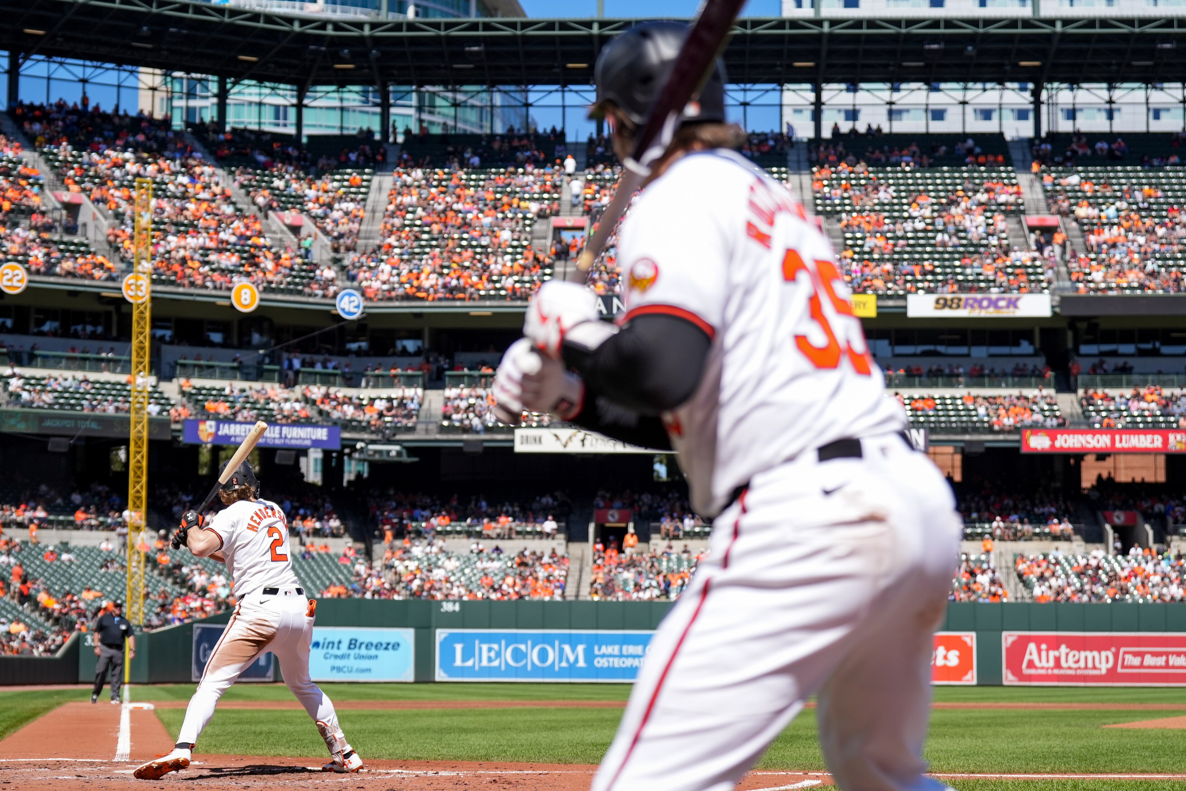 Orioles catcher Adley Rutschman watches from the on-deck circle as shortstop Gunnar Henderson bats Sunday at Camden Yards.