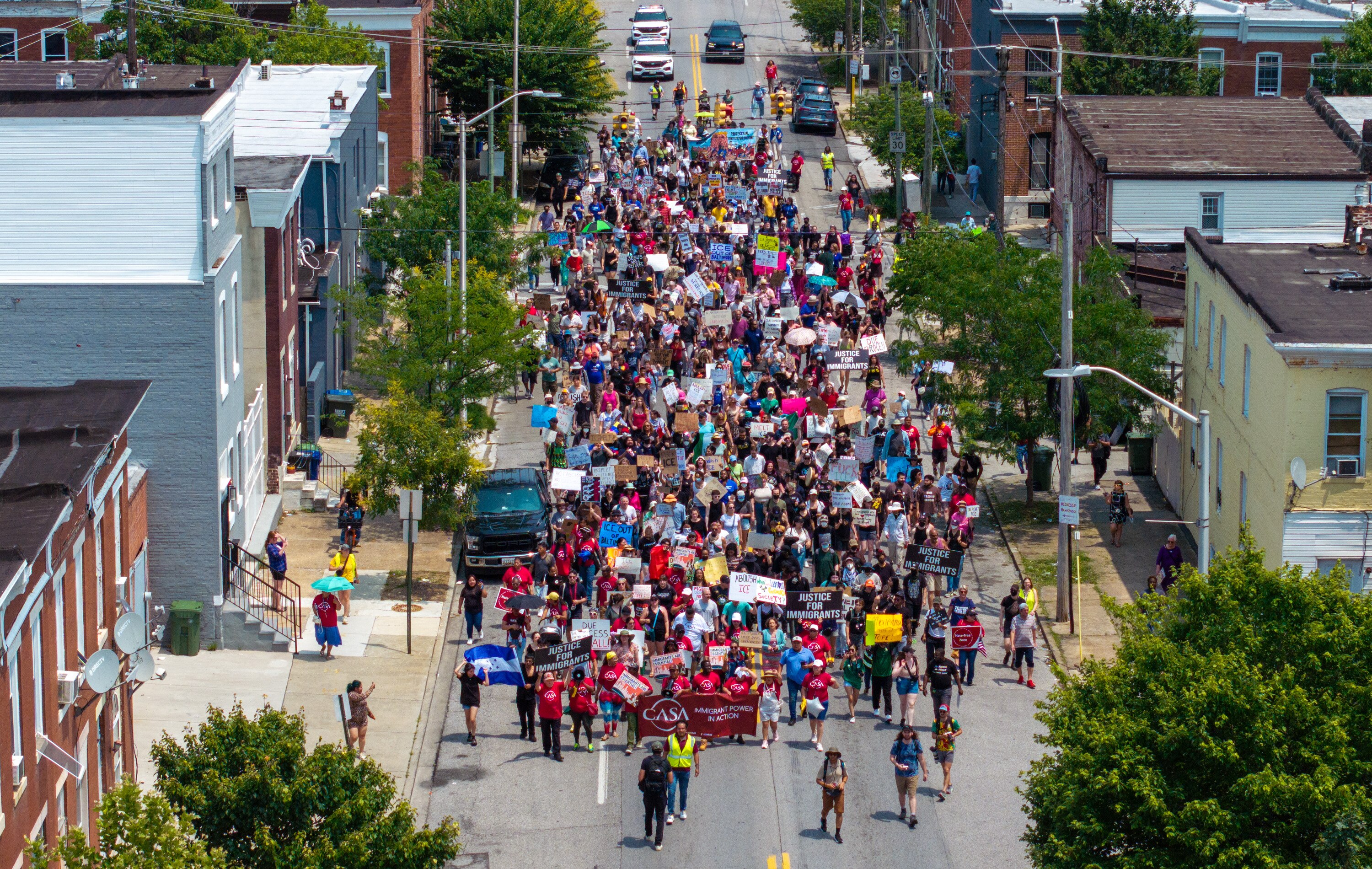 Hundreds of protesters march down E. Fayette Street on Wednesday afternoon to signal their increasing distress over an intense immigration crackdown that has sparked protest and unrest across the country.