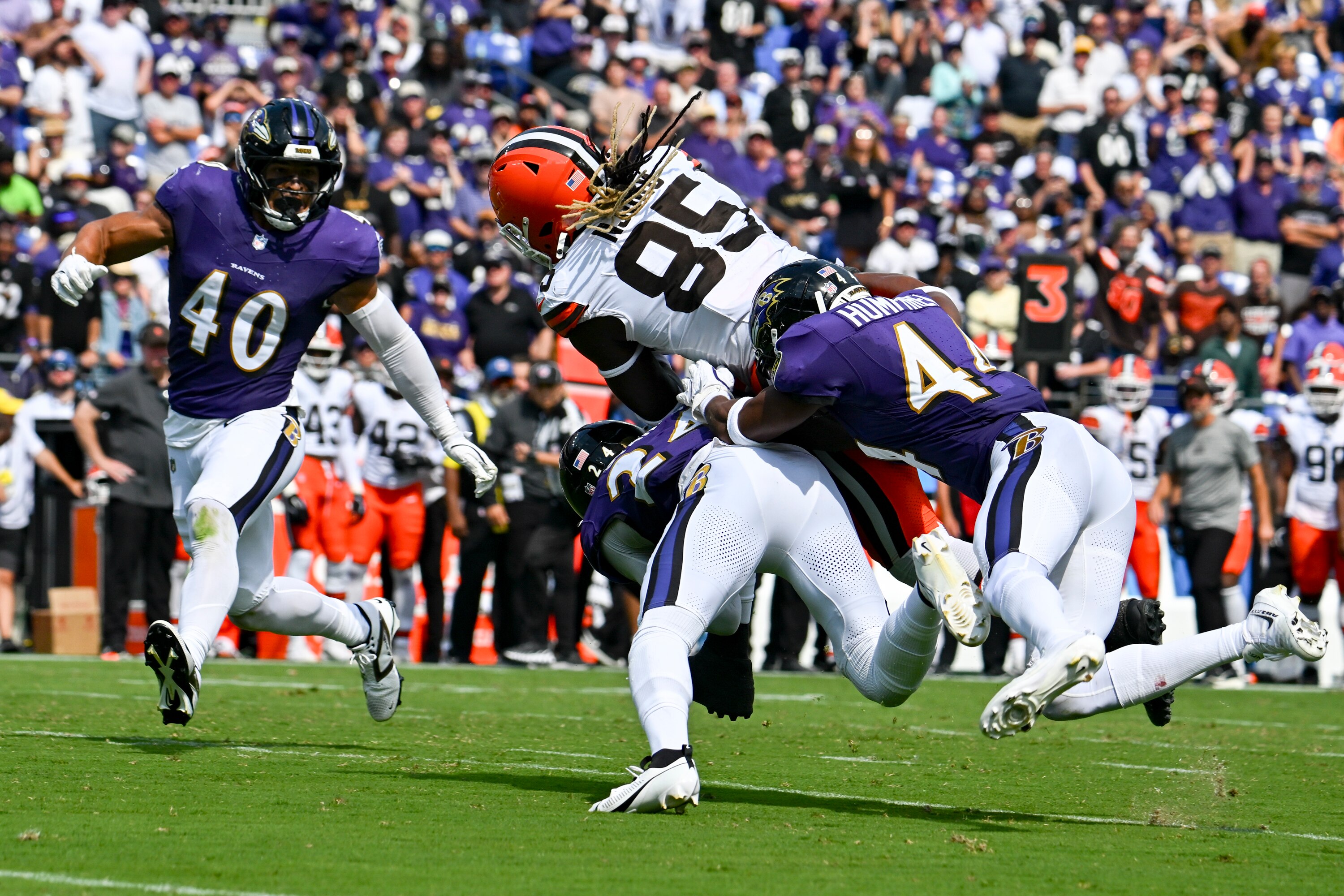 Ravens cornerback Marlon Humphrey and safety Malaki Starks tackle Cleveland Browns tight end David Njoku on Sunday.
