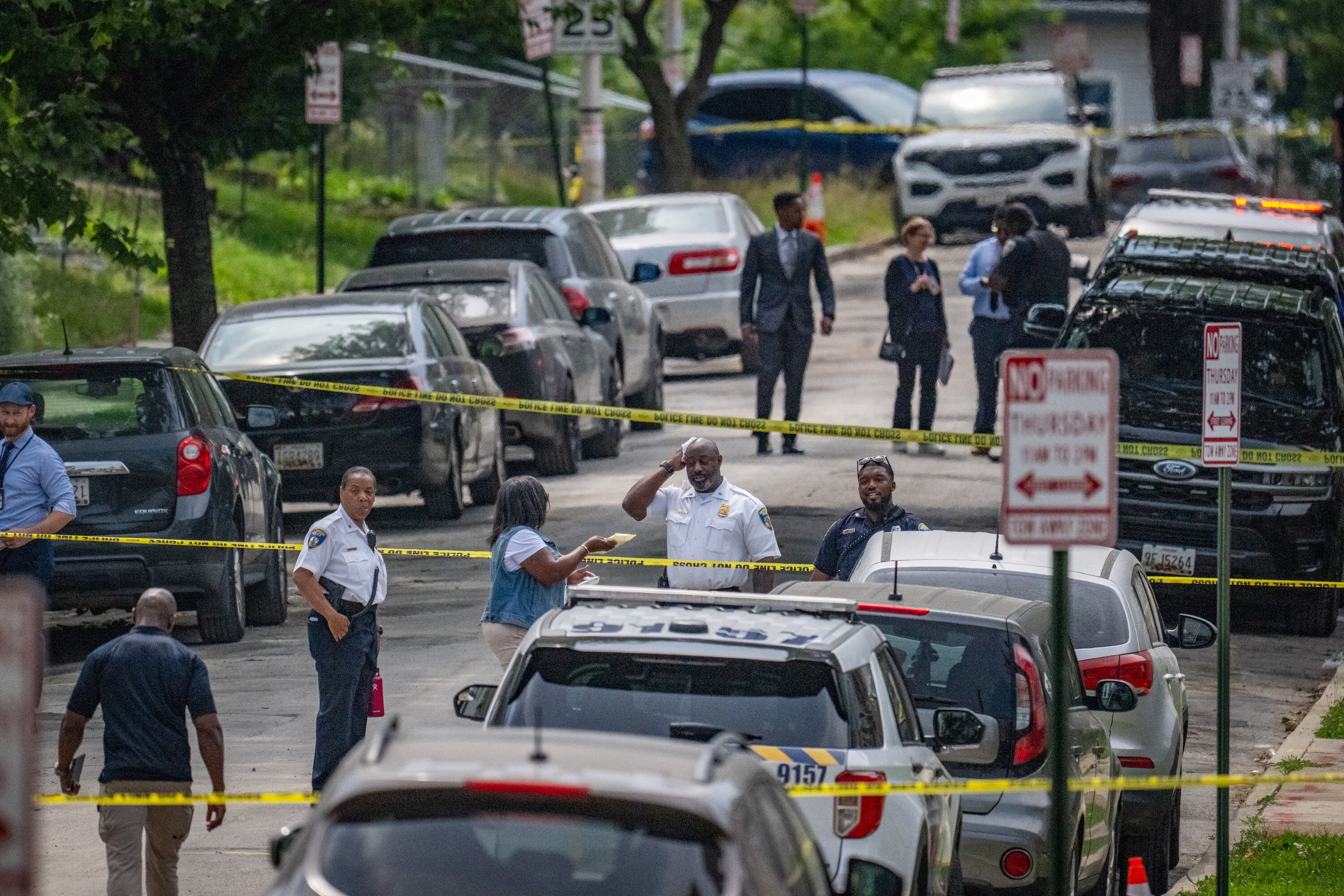Baltimore Police officers on scene of a shooting on the 2700 block of Mosher Street on Wednesday. The woman and officers in that shooting were identified.
