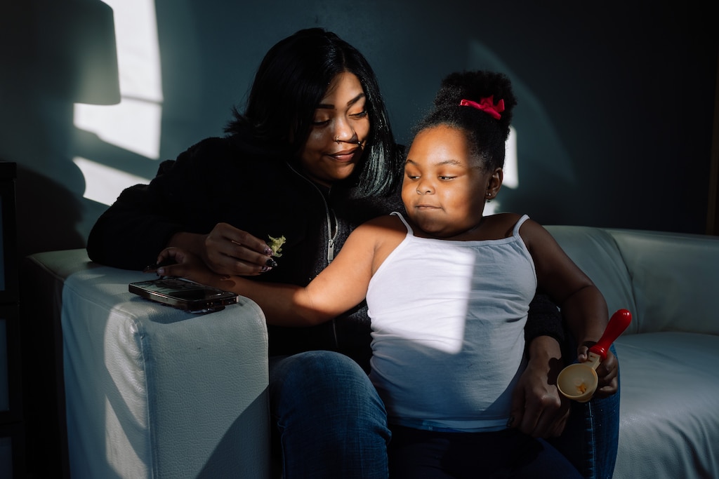 Monique Polley plays with toy dinosaurs with her daughter, Aniyah, 4, in her mother’s home, in Baltimore, MD on Thursday, Dec. 4, 2025.