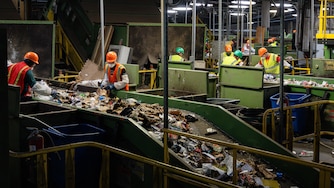 Workers sort through multiple sets of conveyor belts of recycled materials within the Materials Recovery Facility at the Baltimore County Central Acceptance Facility, as seen during a tour of the facility on May 23rd, 2025 in Cockeysville, MD.