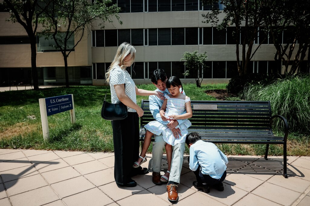 BALTIMORE, MD - July 23, 2025: Siblings, Jackson, 19, Rachel, 18, Jacob, 10, and Riley Hoang, 6, wait outside the Edward A. Garmatz United States District Courthouse in Baltimore, Maryland on July 23, 2025. They are attending a hearing for their mother, Melissa Tran, who filed a writ of habeas corpus against ICE for unlawful detainment.