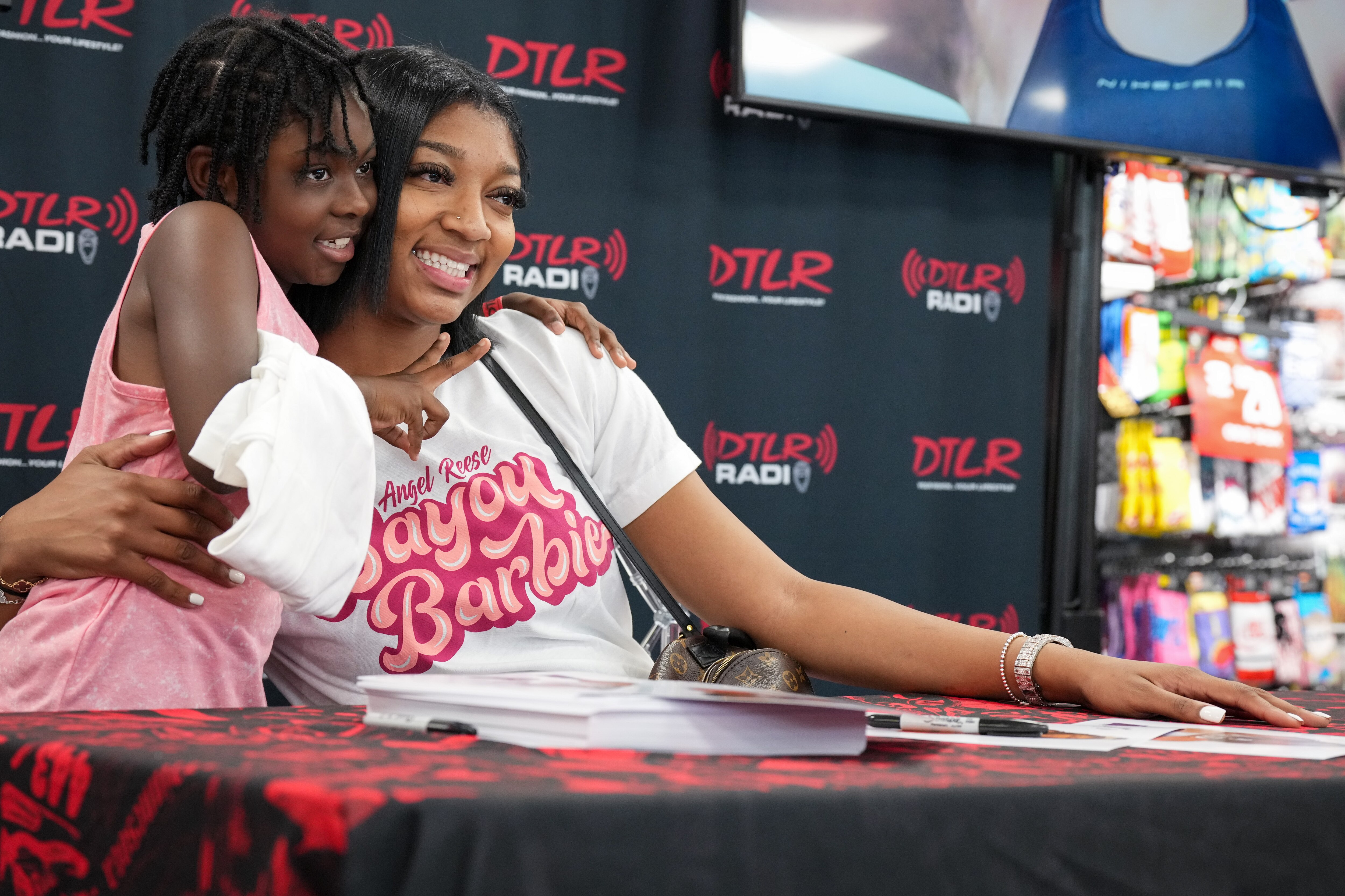 LSU Tigers forward Angel Reese takes a photo with Erin, 8, at the DTLR apparel store near Morgan State University on July 17, 2023. The college women’s basketball star formerly played at St. Frances Academy high school in Baltimore before playing for the Maryland Terrapins and later transferring to Louisiana State University.