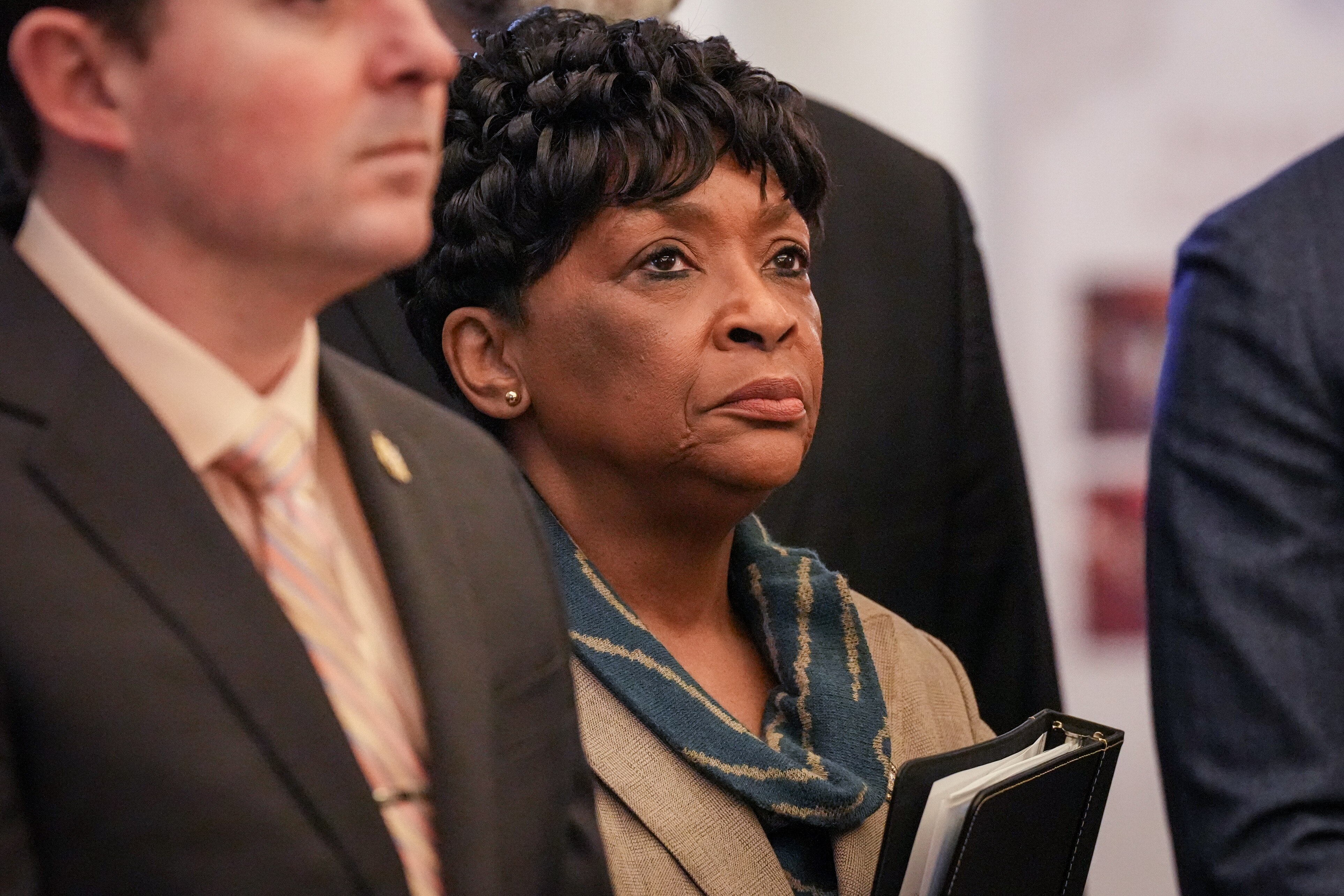 House Speaker Adrienne A. Jones listens as Gov. Wes Moore announces new juvenile justice legislation in the Maryland State House lobby on January 31, 2024.
