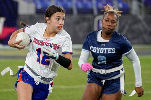 Clarksburg’s Logan Edwards (9) chases after Boonsboro’s Mylee Hartman (12) during the 2024 Maryland High School Girls Flag Football Championship