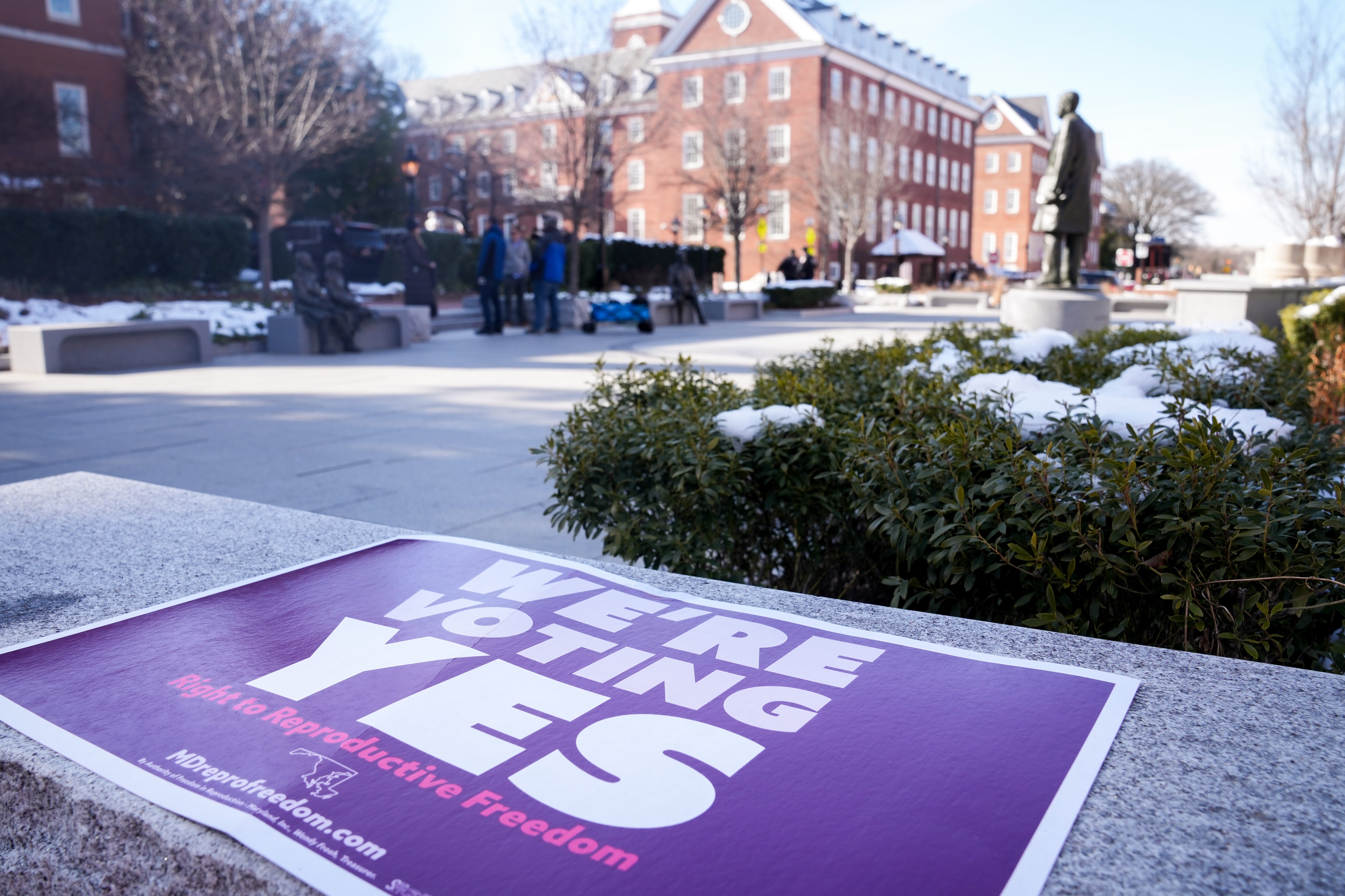 A “WE’RE VOTING YES” sign is seen on a bench outside the Maryland State House following a reproductive rights presser on Lawyers Mall on Jan. 22, 2024. Voters will decide if abortion is a right that will be included in the state constitution.