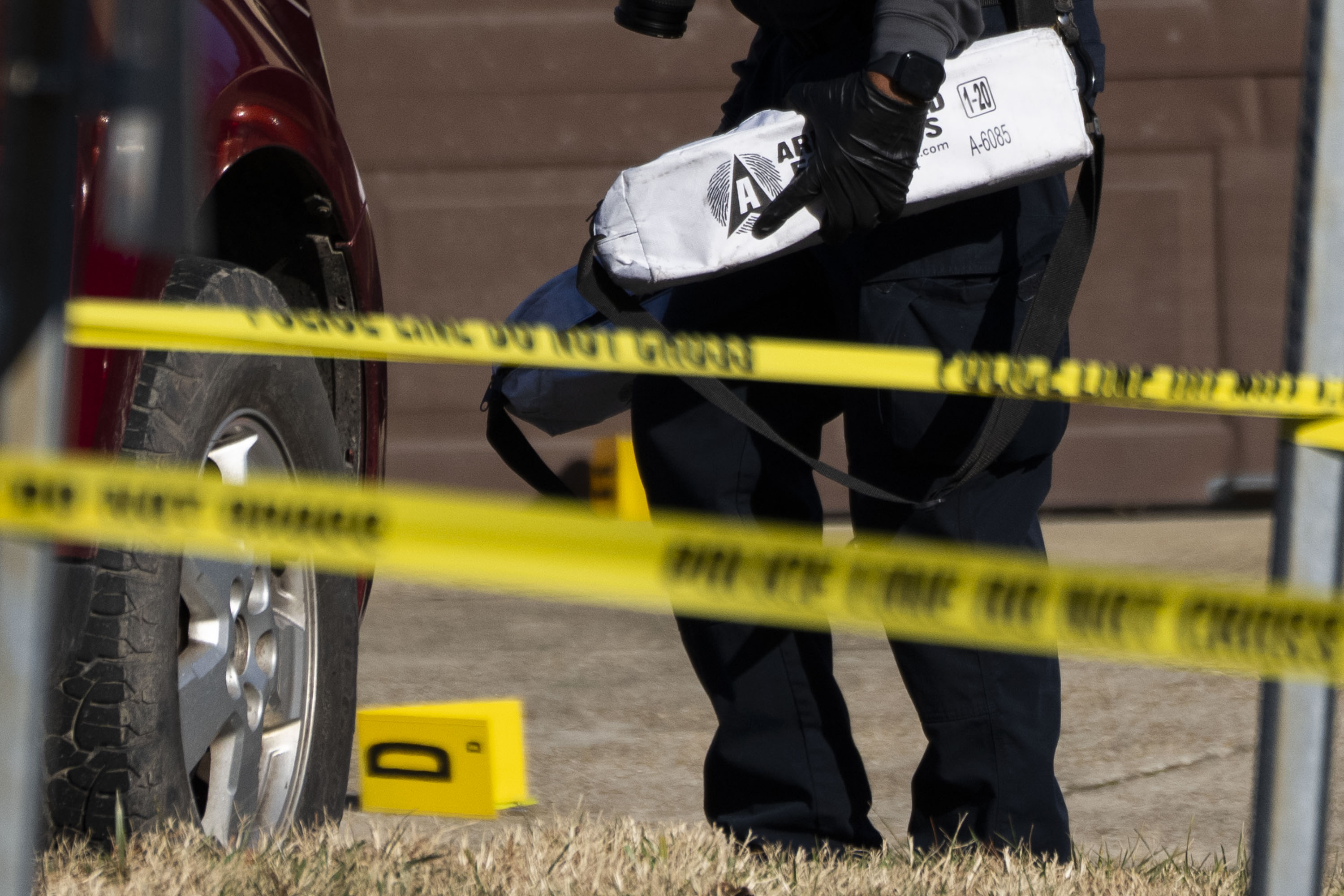 Investigators comb the scene of a shooting involving ICE agents on Christmas Eve in Glen Burnie.