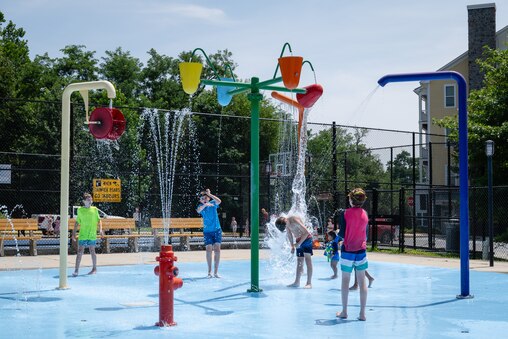 Children play in the Splash Pad at Roger Carter Community Center Pool in Howard County on August 4th, 2025 in Ellicott City, MD.