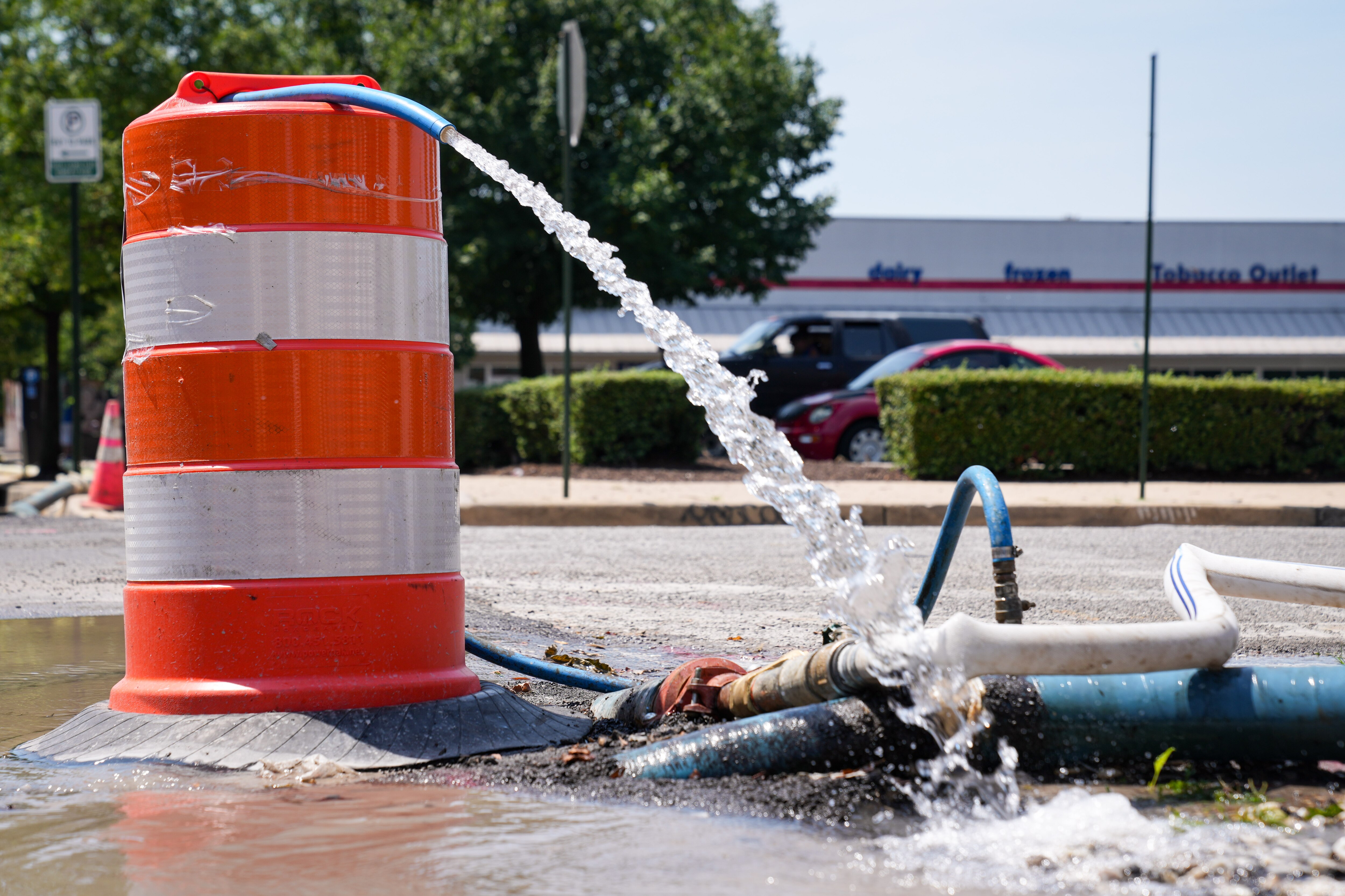 An exposed water pipe on Maryland Avenue in Old Goucher pumps out water into the street on July 17, 2024.