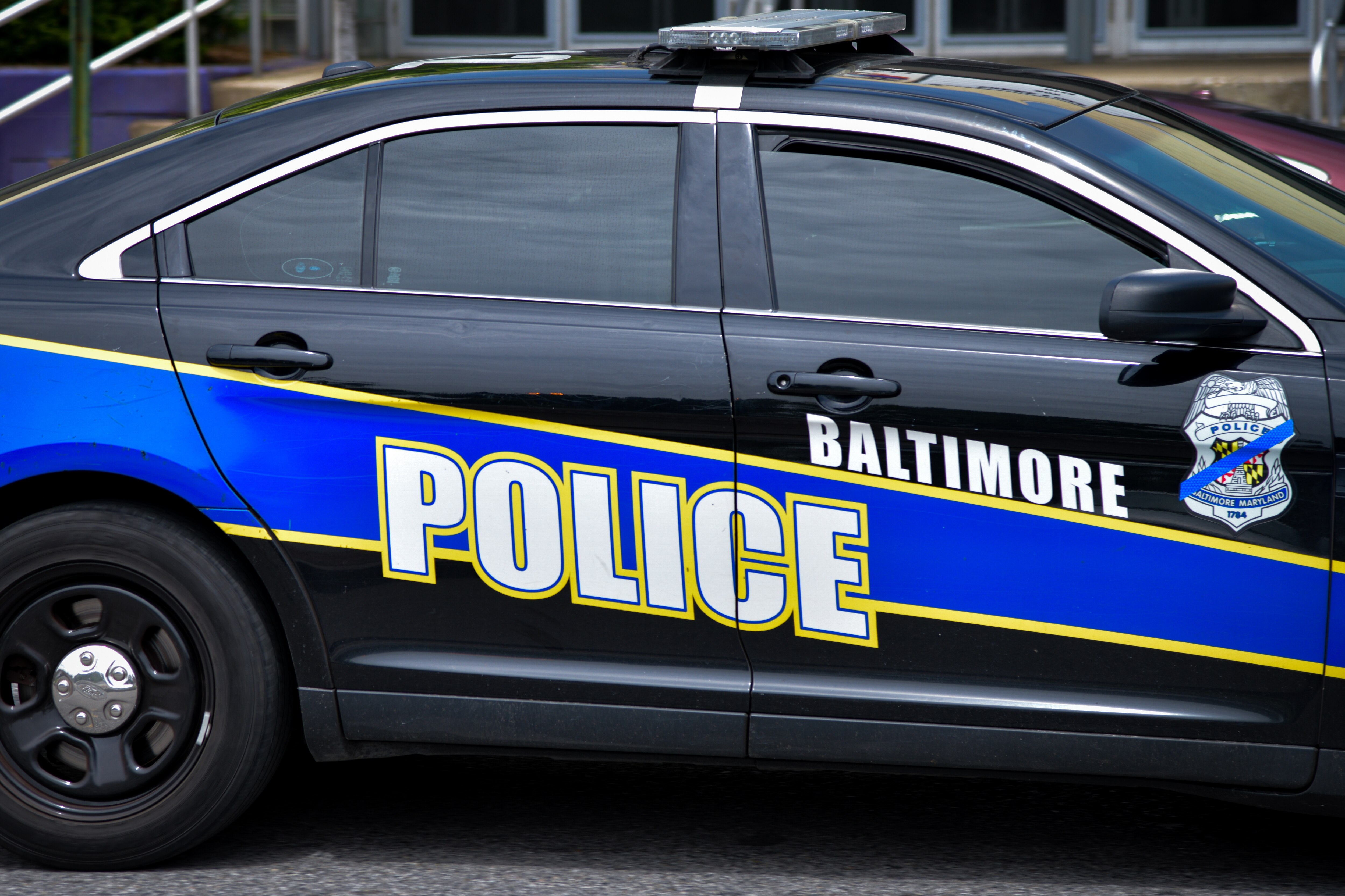 A Baltimore Police car drives down Pennsylvania Avenue.