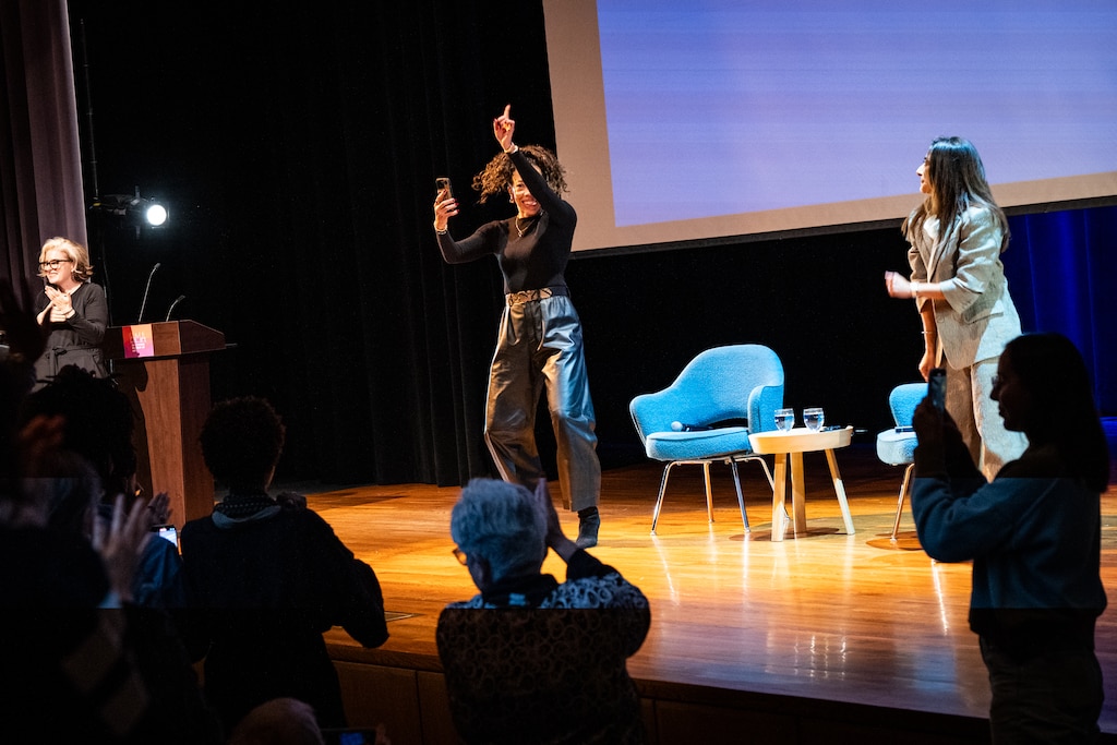 Artist Amy Sherald films on her phone as she takes the stage, dancing to Lil Wayne’s “A Milli” ahead of “A Baltimore Homecoming: Amy Sherald & Asma Naeem in Conversation” at the Baltimore Museum of Art.