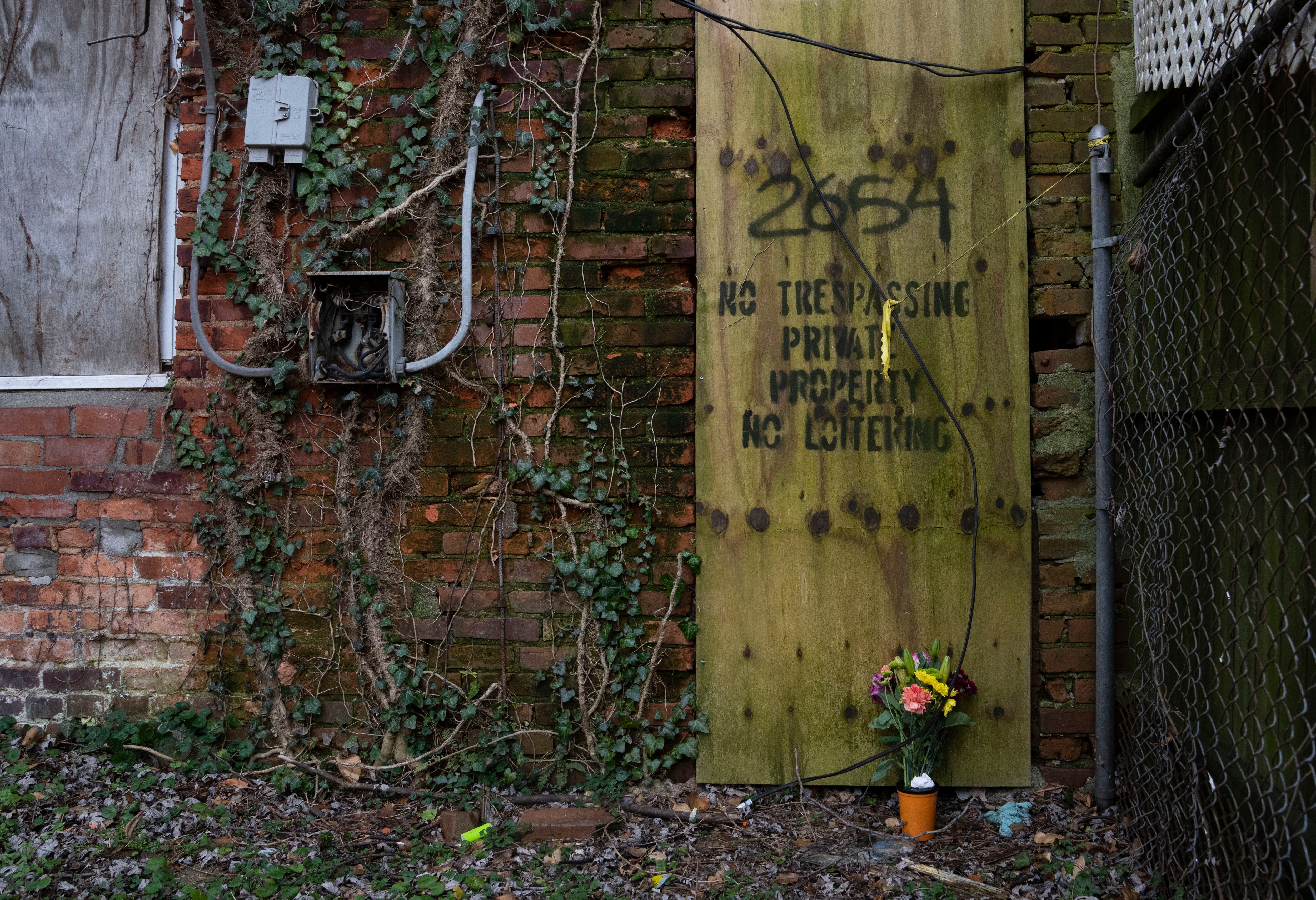 Flowers laid by Mona Setherley at the rowhome where her son, Bruce Setherley, was discovered deceased from an overdose in Baltimore on February 15, 2024.