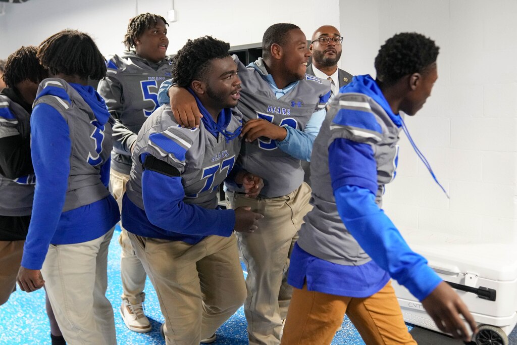 Student athletes react to seeing their newly renovated weight room during ‘Armour Day’ at Carver Vocational Technical High School in Baltimore, Md., on Monday, Sept. 15, 2025.