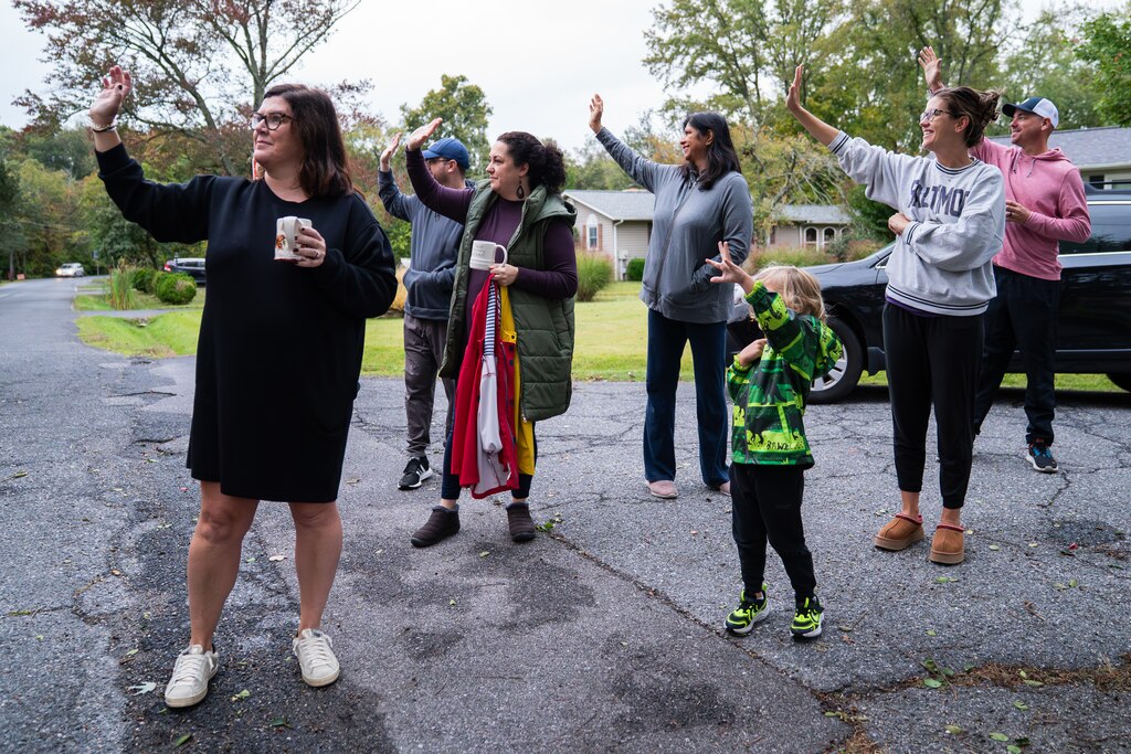 MONDAY, OCTOBER 13, 2025 — Parents and other family members, including Amanda Fisher, left, wave goodbye to their children as they head to Davidsonville Elementary School in Riva, MD.