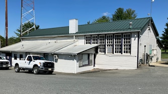 The Rosenwald School in Poolesville has been transformed into an office for the DOT facility. The floors have been removed but the original walls and some of the eight-foot windows remain.
