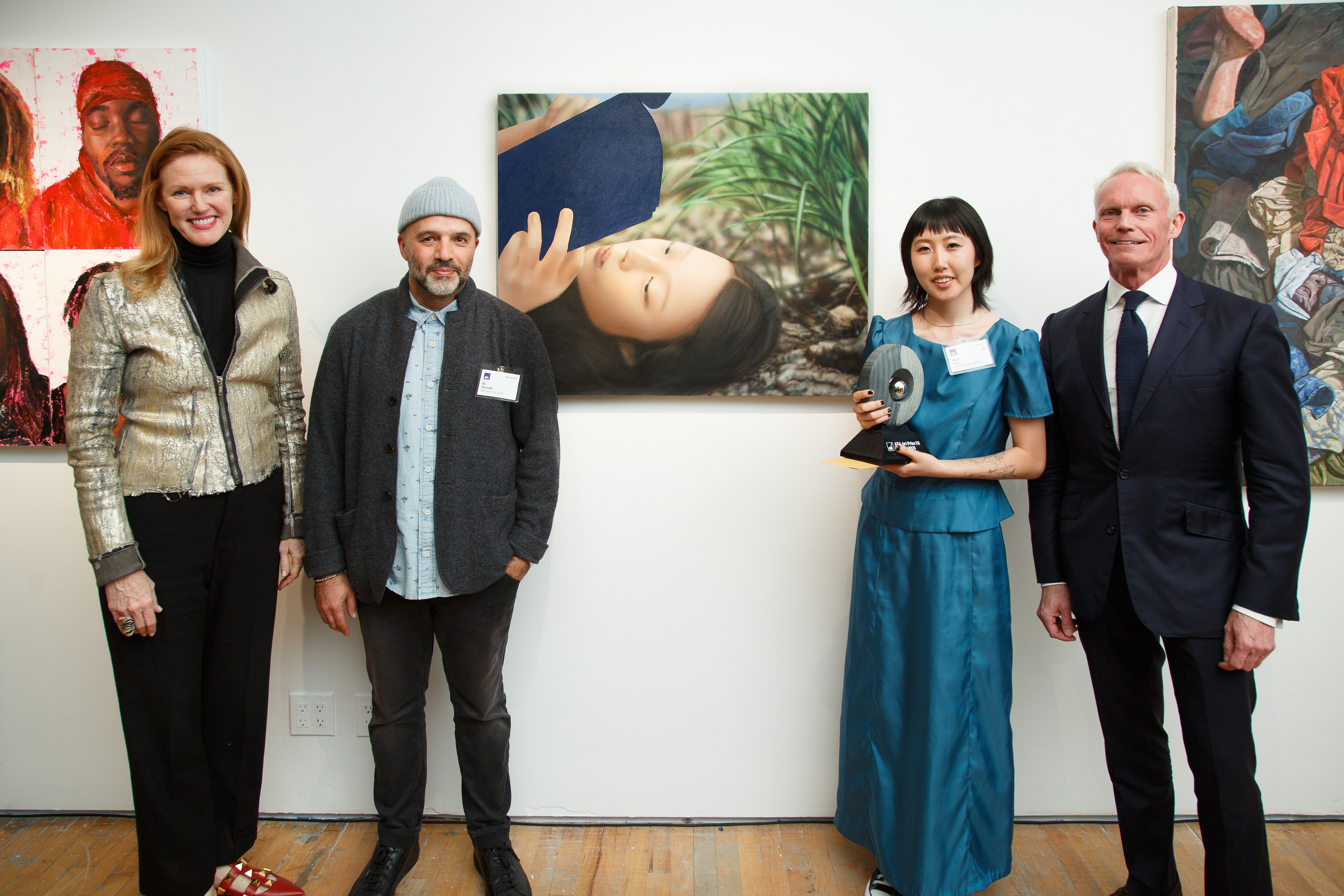 Maryland Institute College of Art senior Hazel Paik, second to right, stands next to her painting “Green Sun” and jury members after winning the AXA Art Prize in New York.