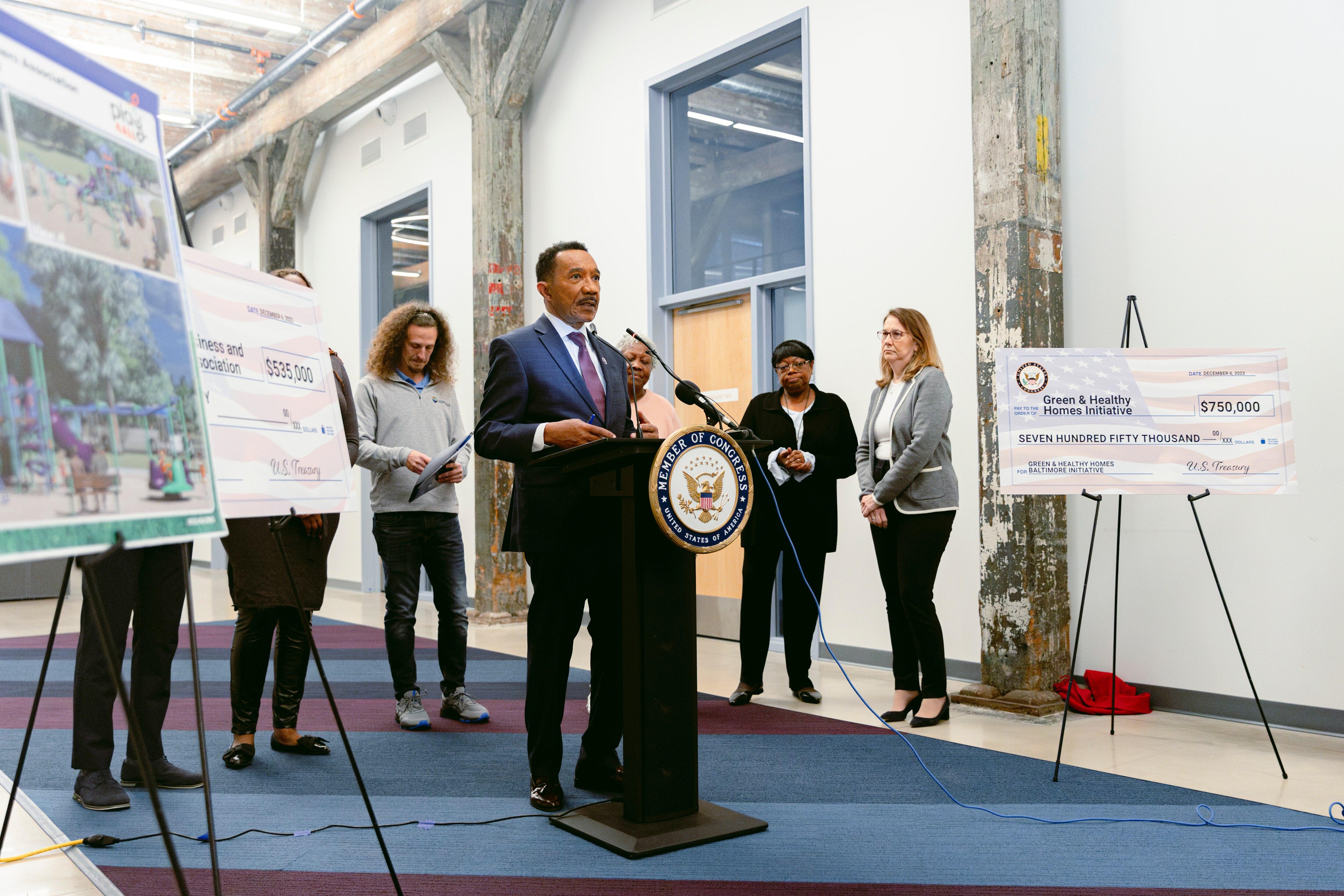 Rep. Kweisi Mfume speaks to a crowd gathered at a press conference where he awarded congressional funding for community projects in Baltimore.