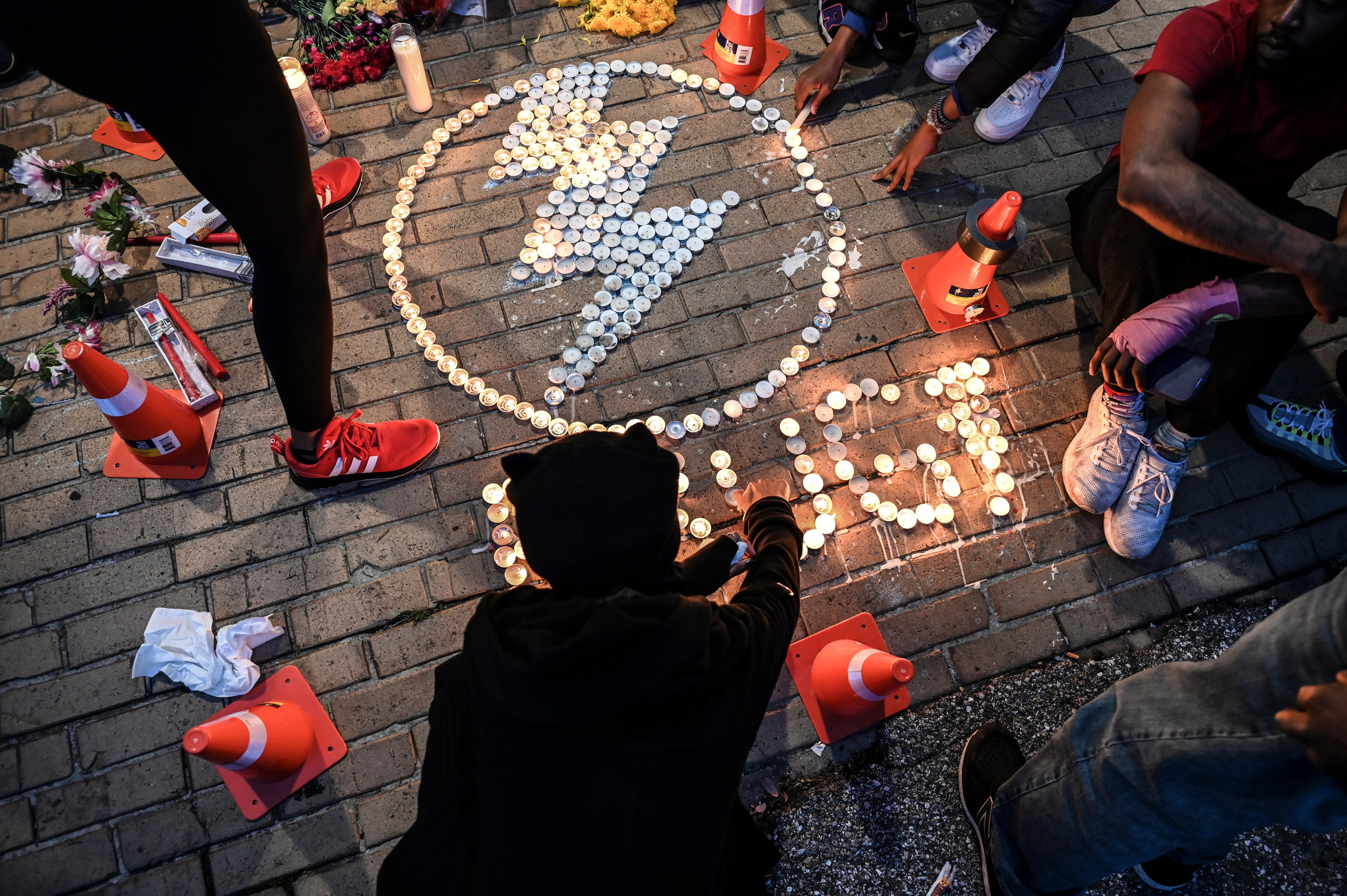 Friends and family of boxer Ernie "Lightening Bug" Hall attend a candlelight vigil at his gym, Lightning Quick Fit in Mount Vernon.