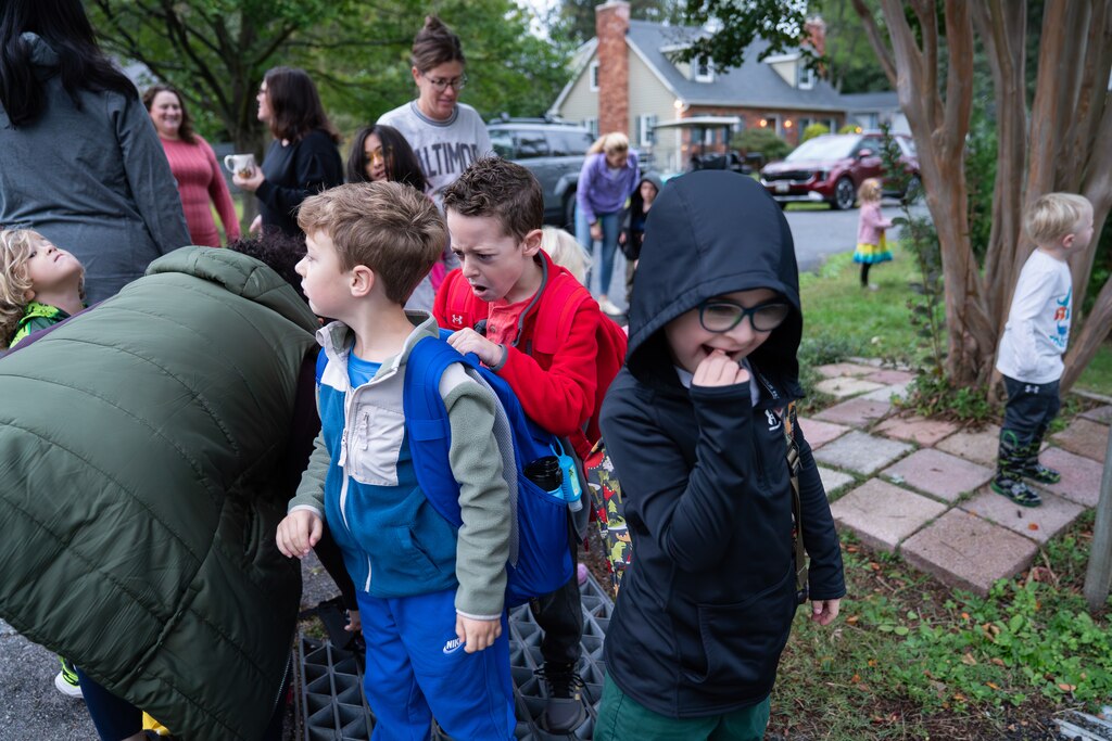 MONDAY, OCTOBER 13, 2025 — Parents and students, including Waylon Fisher, center right, wait for the school bus to Davidsonville Elementary School in Riva, MD.