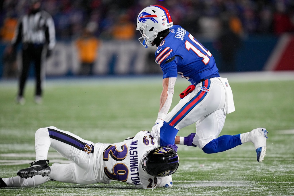 Baltimore Ravens safety Ar'Darius Washington (29) hangs onto Buffalo Bills wide receiver Khalil Shakir’s leg to tackle him in a divisional round playoff game at Highmark Stadium in Orchard Park, NY. on Sunday, January 19, 2025.