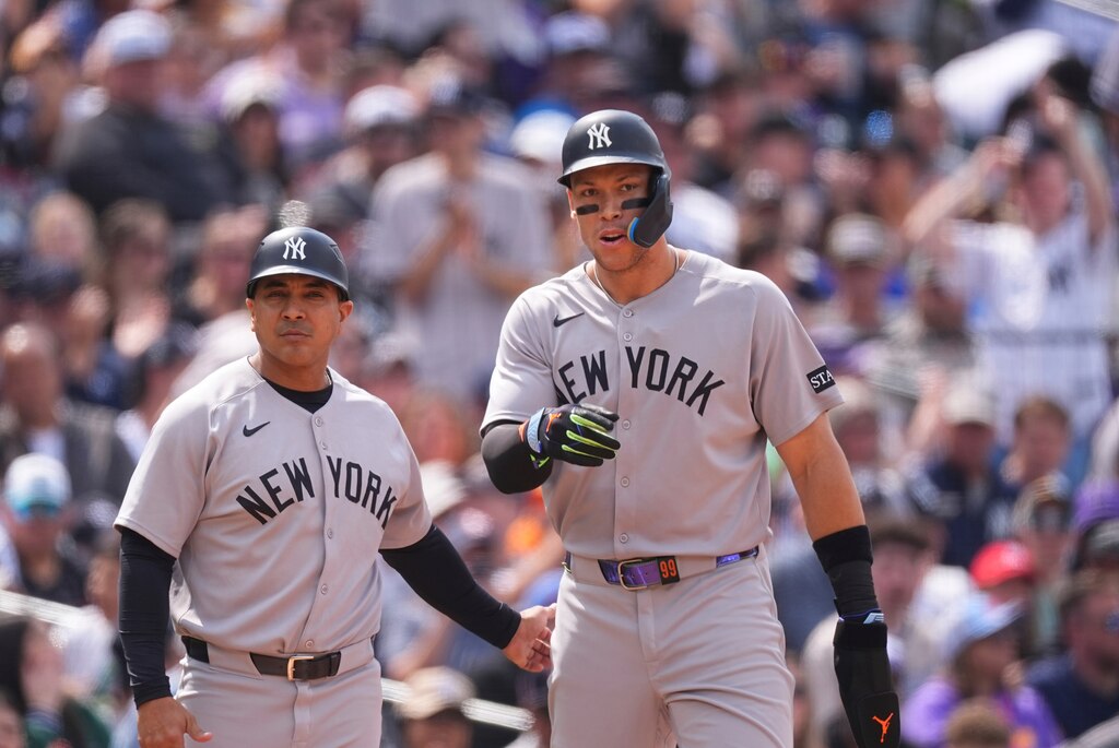 New York Yankees third base coach Luis Rojas and Aaron Judge in May.
