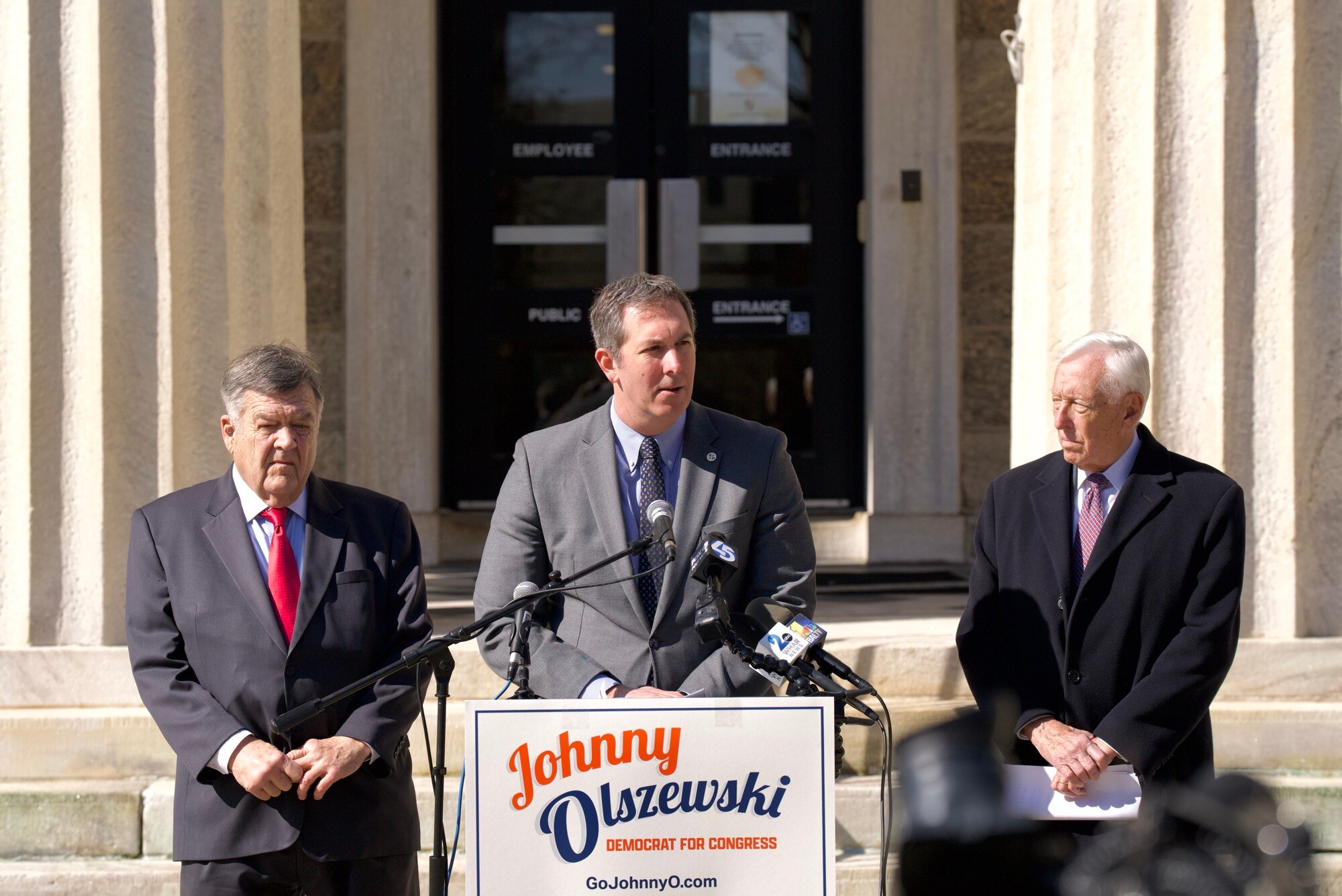 Rep. Dutch Ruppersberger (left) and Rep. Steny Hoyer (right), endorse Johnny Olszewski Jr. for Congress outside of the historic Towson courthouse on Feb. 21, 2024. (Kaitlin Newman/The Baltimore Banner)